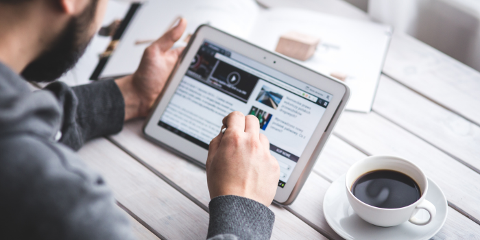 Person reading newsletter on tablet
