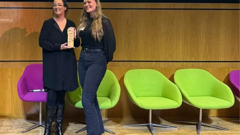 Myrovlytis Trust CEO Alison Taylor (left) presents Jennifer Hertiz with her Dr Anna Webb Award for Best Early Career Researcher at the BHD Symposium in London, October 2023